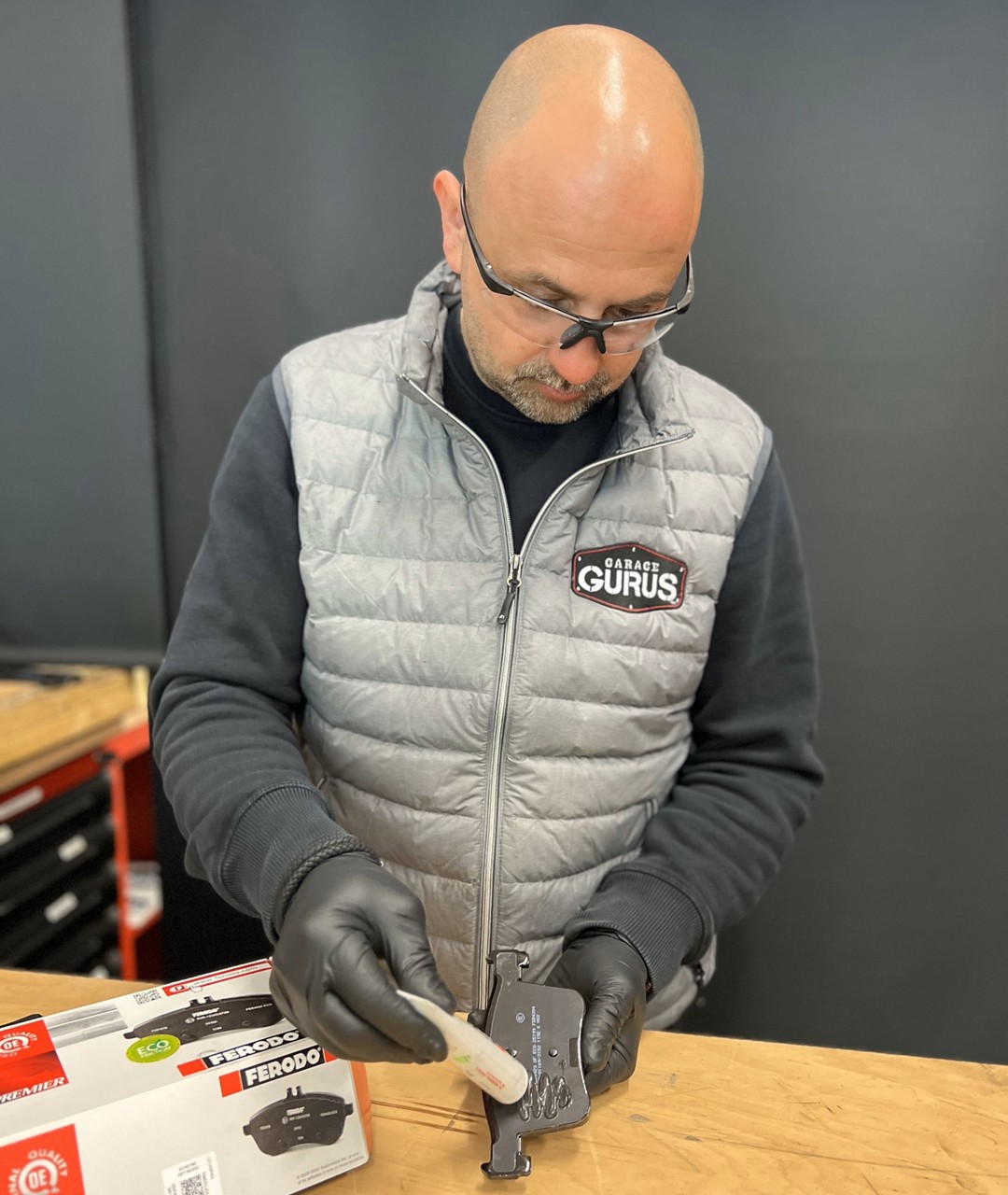 Applying brake grease in brake pads